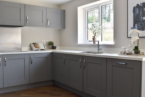 Symphony Cobble Grey Kitchen with White worktops in a U Shape kitchen with Stainless Steel Splashbacks