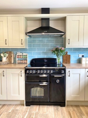 #mysymphonystyle September competition winner kitchen, ivory cabinets with a light wood effect laminate with black range cooker and black extractor fan
